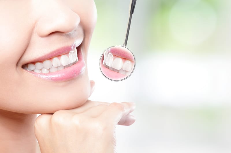 woman smile with dental mirror