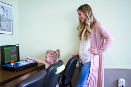 toddler playing games at dentist office in calgary