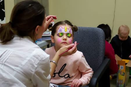 girl getting face painted at metro dental care