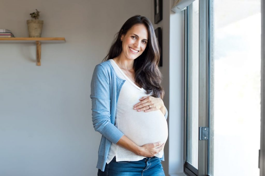 pregnant woman holding her stomach