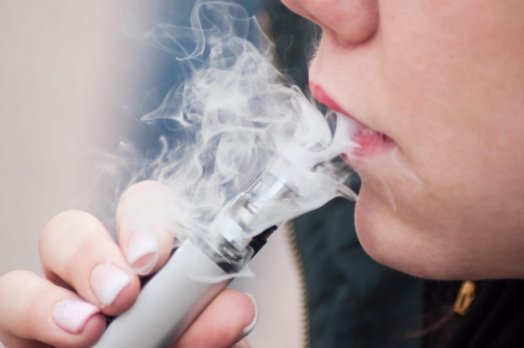 woman smoking an e-cigarette