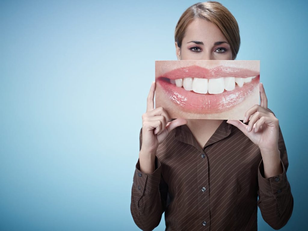 woman with picture of white teeth