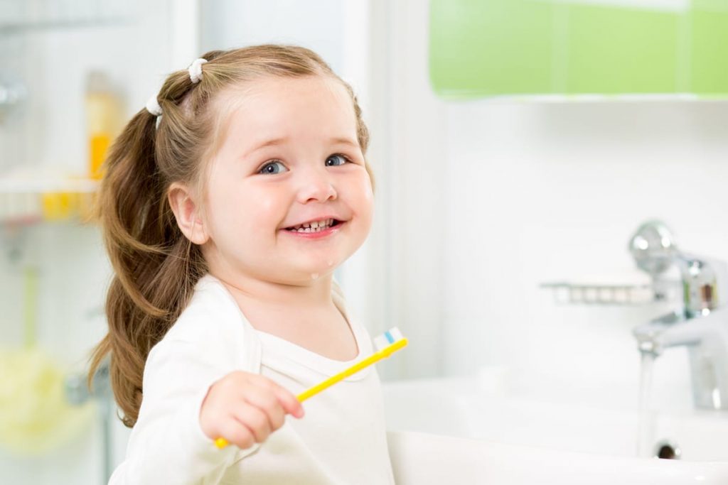 toddler brushing her teeth