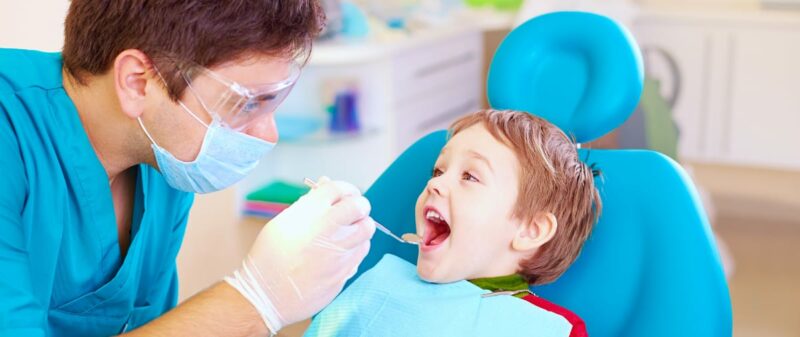 dentist with toddler in exam room