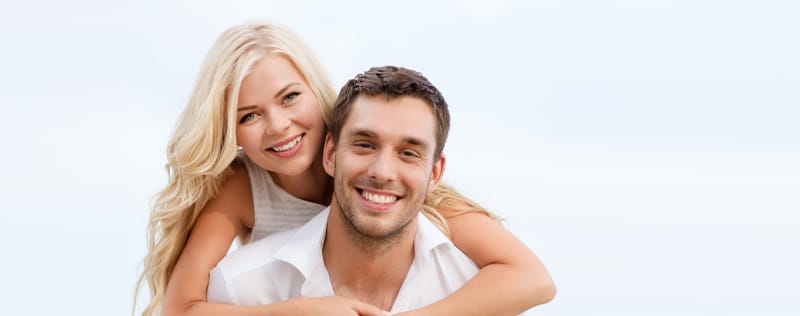 smiling couple with bright smiles after teeth whitening