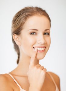 woman pointing to her white smile