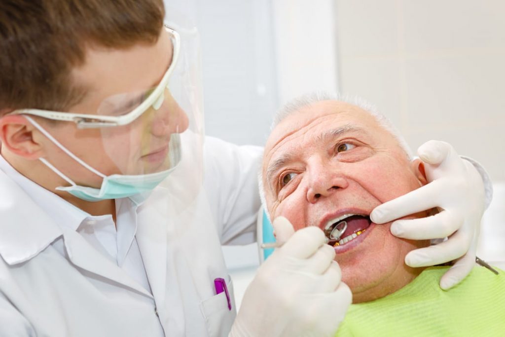 elderly man getting a dental filling