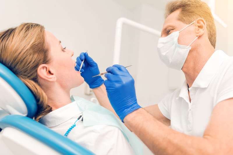 calgary dentist examining a patient