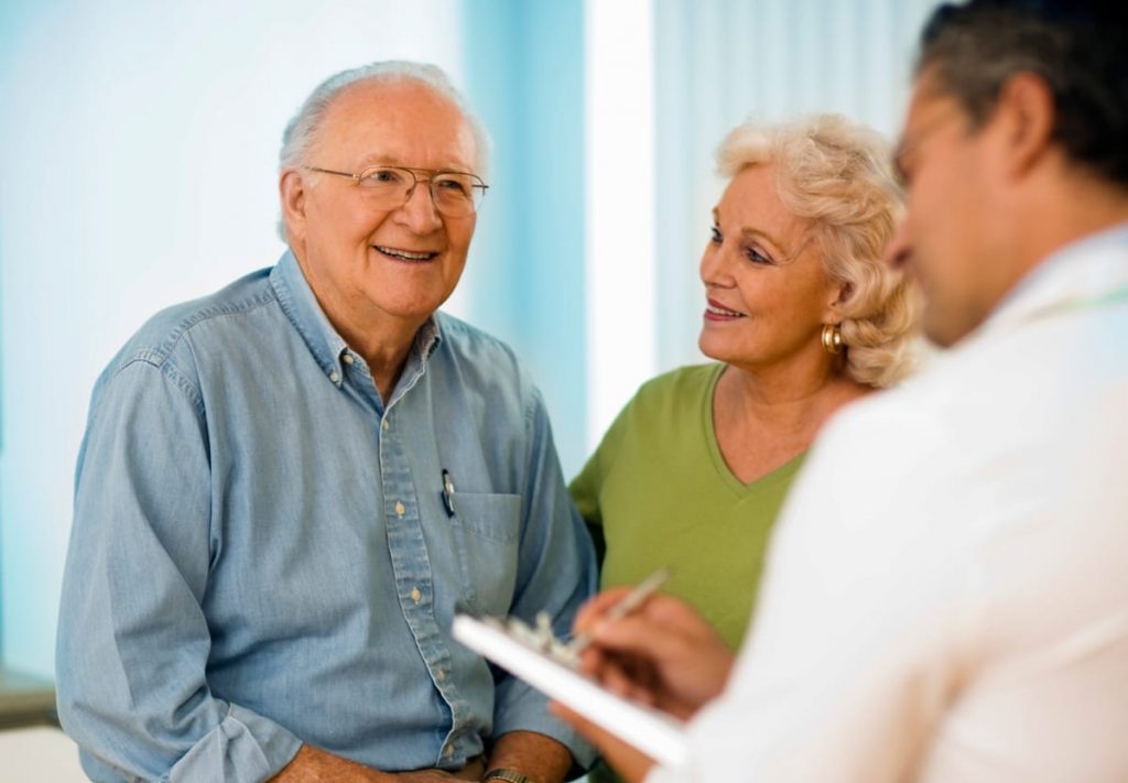 man in exam room with dentist