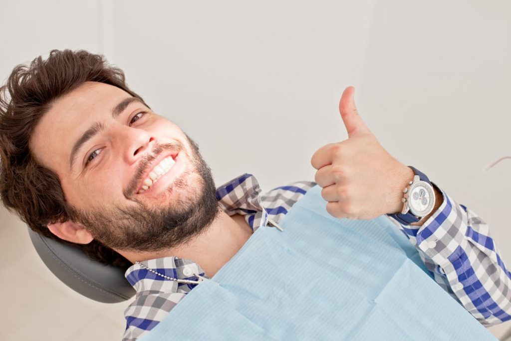 man giving thumbs up after Calgary dental exam