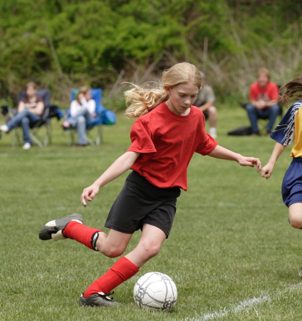 girl playing soccer