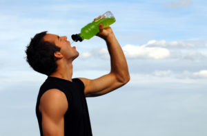 man drinking a sports drink